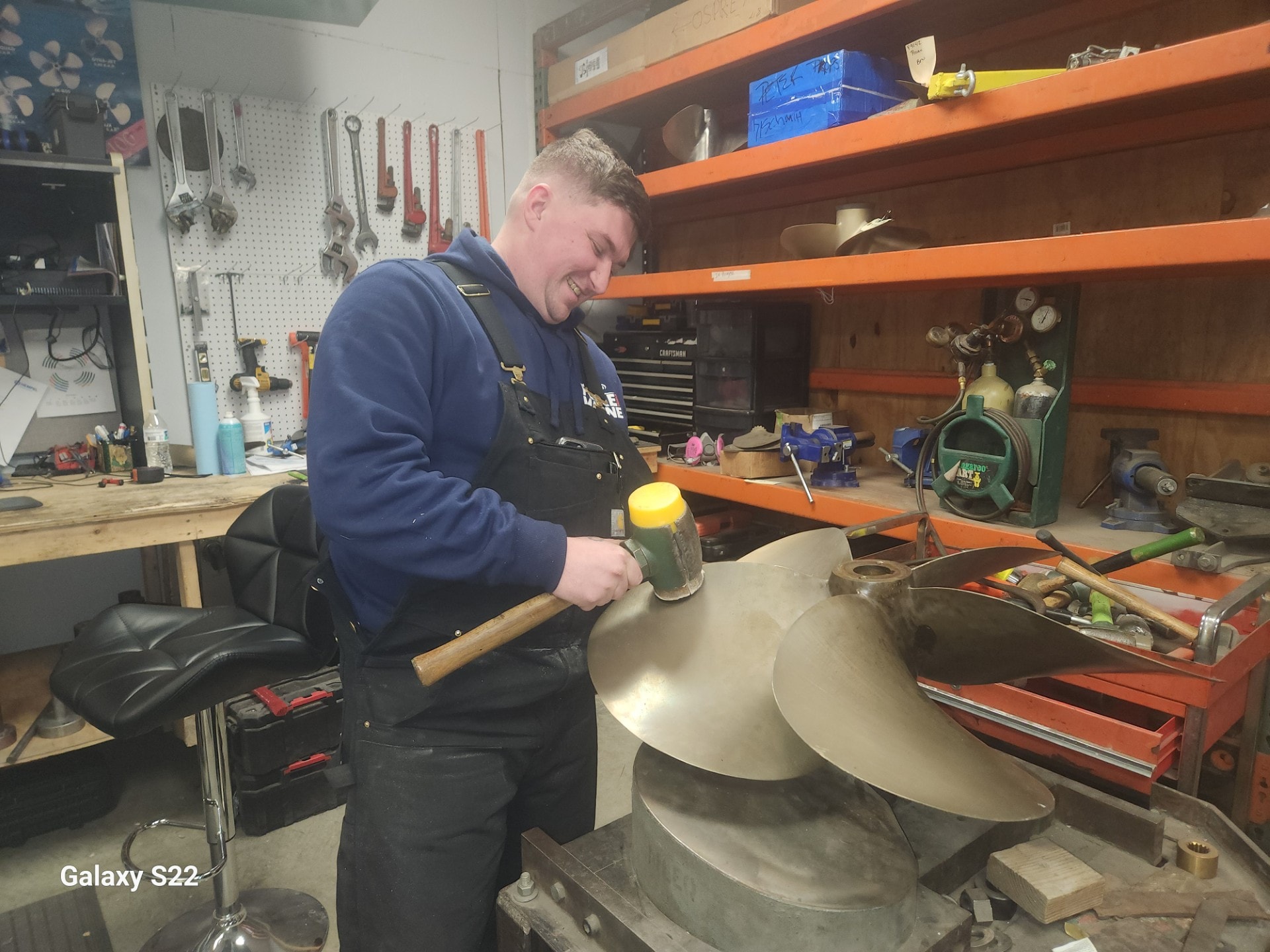 Technician working on propeller reconditioning in the shop